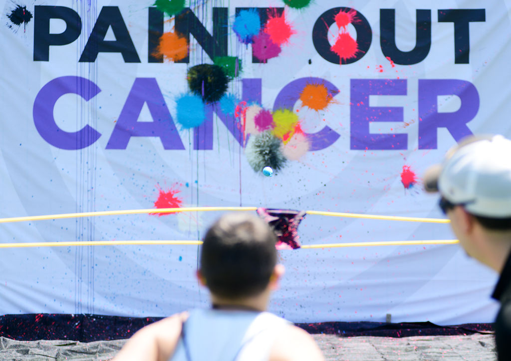 Carter Smith, 9, launches a balloon filled with paint from a sling shot